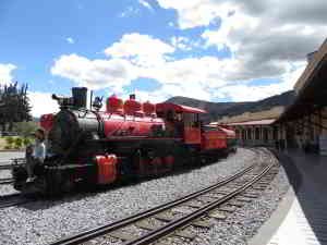 RIDE ECUADOR BY TRAIN, RAIL, RAILROAD & RAILWAY: The fully restored red steam engine on display at the Chambacalle railroad station in Quito. 
