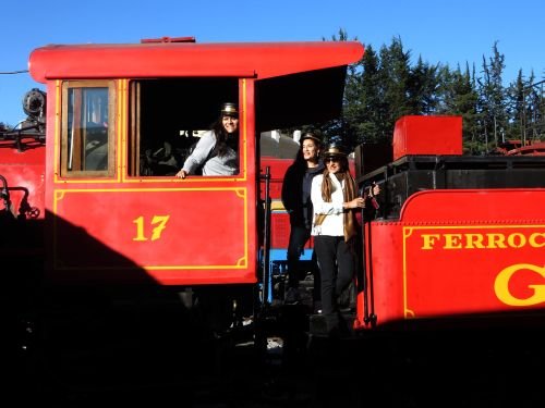 RIDE ECUADOR BY TRAIN, RAIL, RAILROAD & RAILWAY: Passengers enjoying having their picture taken at the steam locomotive in Quito. 